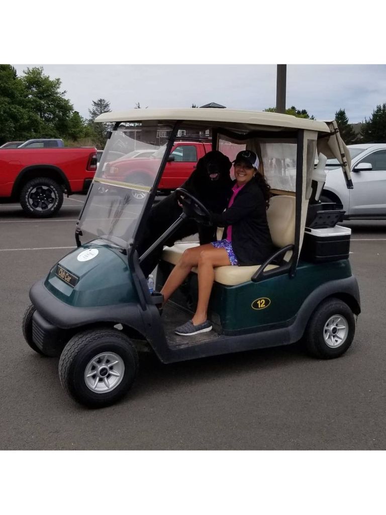Dog and woman in golf cart at Peninsula Golf Course